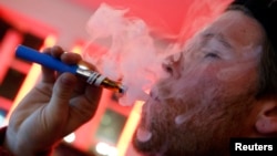 A man with an e-cigarette at an e-cigarette lounge in New York City.
