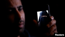 Fouad, the brother of 15 year-old Nora who left her home in Avignon for Syria nine months ago, shows a portrait he took last September on his cellphone as he attends an interview with Reuters in Paris, Oct. 6, 2014. 