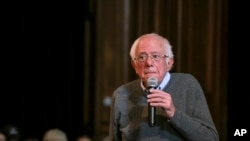 FILE - Democratic presidential candidate Sen. Bernie Sanders listens as an audience member poses a question at a Newport Town Hall Breakfast, at the Newport Opera House in Newport, New Hampshire, Dec. 29, 2019. 