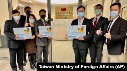 Eric Huang, newly appointed director to the representative office, third from right, poses with other staffers outside the Taiwan Representative Office in Vilinius, Lithuania, Nov. 18, 2021.