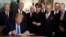 US President Donald Trump signs a presidential memorandum imposing tariffs and investment restrictions on China in the Diplomatic Reception Room of the White House, March 22, 2018, in Washington. 