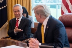 FILE - China's Vice Premier Liu He speaks with U.S. President Donald Trump during a trade meeting in the Oval Office at the White House in Washington, April 4, 2019.