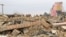 FILE - A Pakistani student stands near remains of a girls school destroyed by alleged militants in Dera Ismail Khan, Pakistan, Feb 3, 2012. Bombing of girls schools is a usual practice of militants fighting against government forces in Pakistan. 