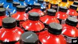 FILE - Sodas and energy drinks line the shelves in a grocery store in Springfield, Illinois, May 18, 2016. The World Health Organization recommends countries use tax policy to increase the price of sugary drinks as a way to fight obesity and diabetes.
