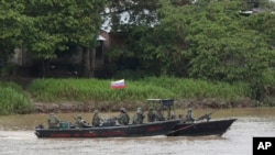 Soldados de la Armada venezolana patrullan el río Arauca, la frontera natural con Colombia, visto desde Arauquita, Colombia, el 26 de marzo de 2021.
