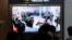 FILE - A TV screen at Seoul Railway Station in South Korea, on Oct. 21, 2024, shows an image of soldiers believed to be from North Korea standing in line to receive supplies from Russia.