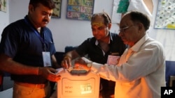 Election officers seal an electronic voting machine at the end of polling in Varanasi, India, May 19, 2019.