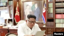 North Korean leader Kim Jong Un reads a letter from U.S. President Donald Trump, in Pyongyang, North Korea, in this picture released by North Korea's Korean Central News Agency, June 22, 2019.