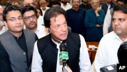 In this photo released by the National Assembly, the leader of Pakistan Tahreek-e-Insaf party Imran Khan,speaks at the National Assembly in Islamabad, Pakistan, Aug. 17, 2018. Pakistani lawmakers Friday elected former cricket star and longtime politician Khan as the country's next prime minister. 