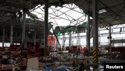 Puing-puing bangunan akibat serangan misil ke kantor pos Ukraina di luar kota Kharkiv, Minggu (22/10). 