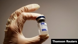 FILE PHOTO: a medical specialist holds a vial of Sputnik V vaccine against the coronavirus in a department store in Moscow, Russia