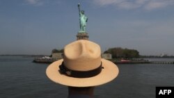 A U.S. park ranger looks towards the Statue of Liberty while in route to Ellis Island on May 27, 2016 in New York City. 
