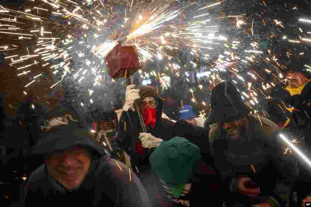 Revelers take part in a "Correfoc," or run with fire, party in Barcelona, Spain.