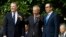 Chinese Vice Premier Liu He, center, flanked by U.S. Trade Representative Robert Lighthizer, left, and Treasury Secretary Steven Mnuchin, gestures to the media before a ministerial-level trade meeting in Washington, Oct. 10, 2019. 