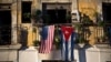 FILE - U.S. and Cuban flags hang from a balcony in Old Havana, Cuba, Dec. 19, 2014.