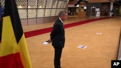 Czech Republic's Prime Minister Andrej Babis stands on a social distancing marker as he makes a statement on arrival for an EU summit at the European Council building in Brussels, July 17, 2020.