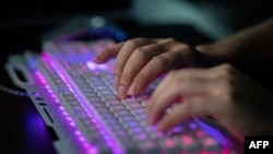FILE - A member of a group of hackers uses his computer at the group's office in Dongguan, China, Aug. 4, 2020. Chinese hackers blamed for spying on U.S. presidential campaigns and American officials are still entrenched in those systems, say senior U.S. officials.